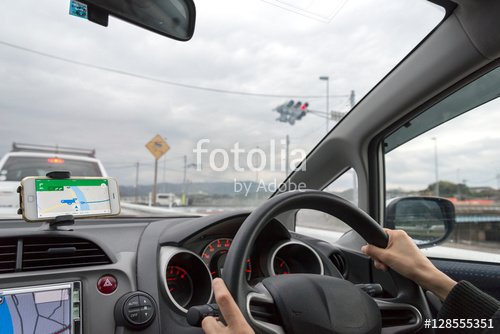 woman driving a car using navigation system woman driving a car using navigation system